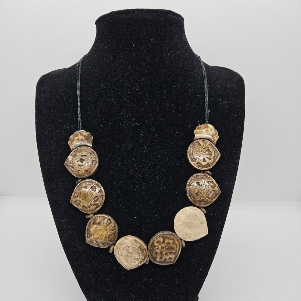carved coconut shell beaded necklace on black cord